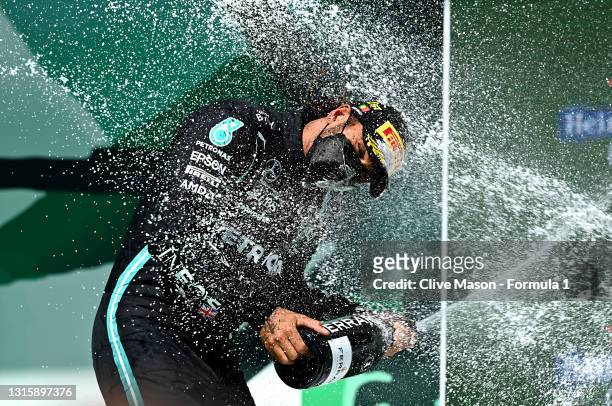 Race winner Lewis Hamilton of Great Britain and Mercedes GP celebrates with sparkling wine on the podium during the F1 Grand Prix of Portugal at...