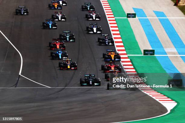 Valtteri Bottas of Finland driving the Mercedes AMG Petronas F1 Team Mercedes W12 leads the field into turn one at the start during the F1 Grand Prix...