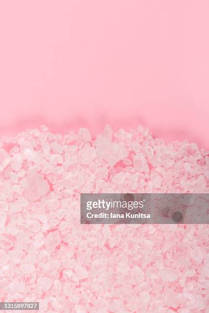 sea salt seasoning on pink background. bath salt for scrubbing and cleansing skin. vertical. copy space. exfoliation scrubber. - bath salt ストックフォトと画像
