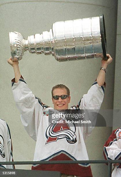 Colorado Avalanche winger Ville Nieminen of Finland shows the Stanley Cup to fans during a victory rally at the City and County Building June 11,...