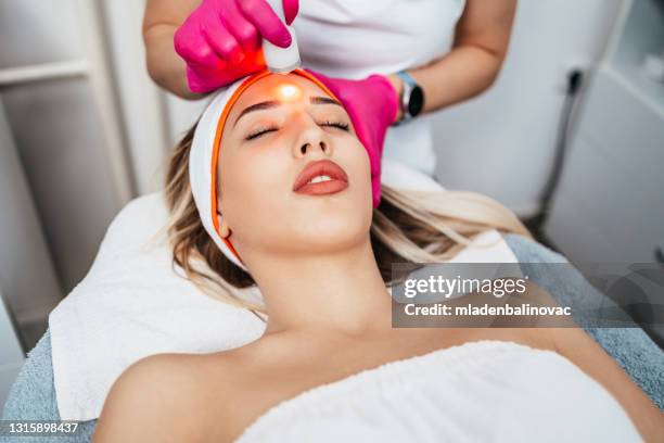 face treatment - medical laser stock pictures, royalty-free photos & images