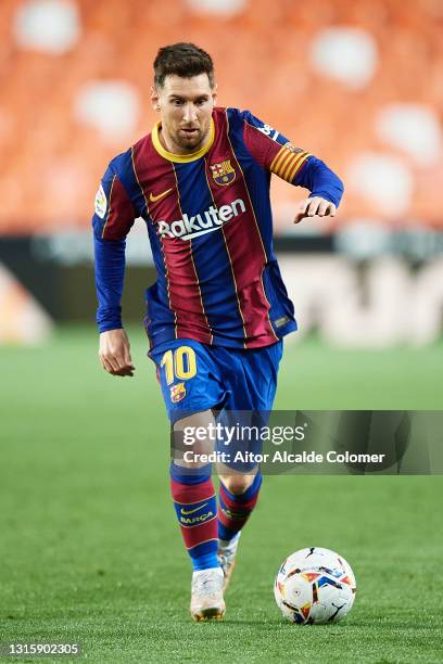 Lionel Messi of FC Barcelona in action during the La Liga Santander match between Valencia CF and FC Barcelona at Estadio Mestalla on May 02, 2021 in...