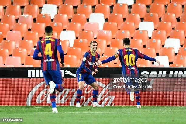 Antoine Griezmann of FC Barcelona celebrates with team mate Lionel Messi after scoring their side's second goal during the La Liga Santander match...