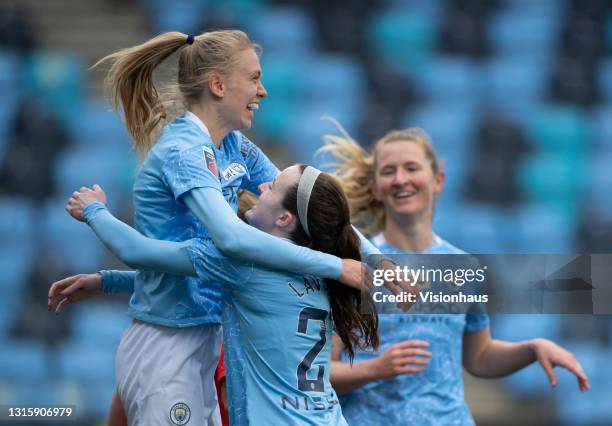 Esme Morgan of Manchester City celebrates scoring the third goal with team mates Sam Mewis and Rose Lavelle during the Barclays FA Women's Super...