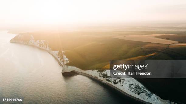 an aerial sunset view of durdle door in dorset - stock photo - dorset photos et images de collection