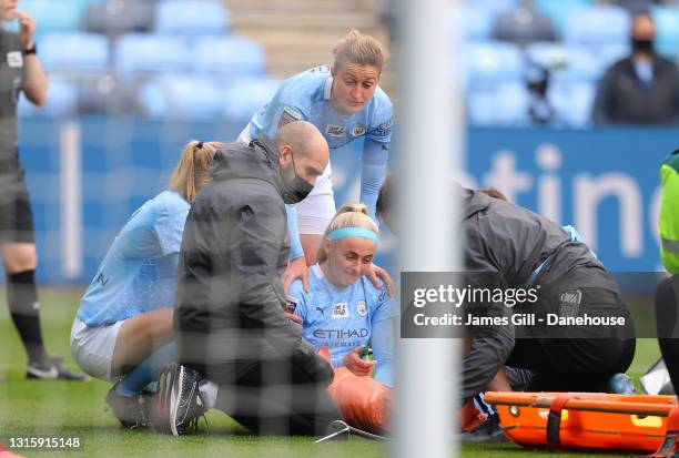 Chloe Kelly of Manchester City Women lies injured after clashing with Rebecca Holloway of Birmingham City Women during the Barclays FA Women's Super...