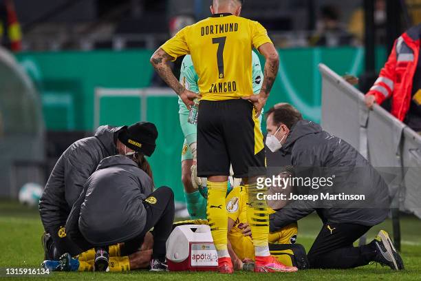 Mateu Morey of Borussia Dortmund receives medical treatment during the DFB Cup semi final match between Borussia Dortmund and Holstein Kiel at Signal...
