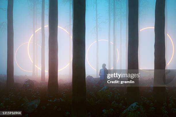 woman sitting in fantasy forest at night - alien arrival stock pictures, royalty-free photos & images
