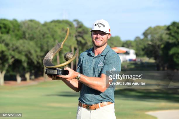 Sam Burns of the United States celebrates with the trophy after winning during the final round of the Valspar Championship on the Copperhead Course...