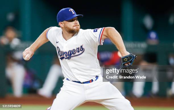 Relief pitcher Ian Kennedy of the Texas Rangers throws during the ninth inning of a baseball game against the Boston Red Sox at Globe Life Field May...