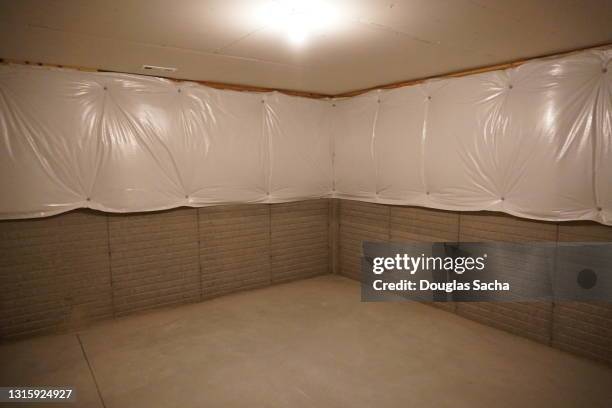 vapor barrier on a basement wall - wasserdicht stock-fotos und bilder