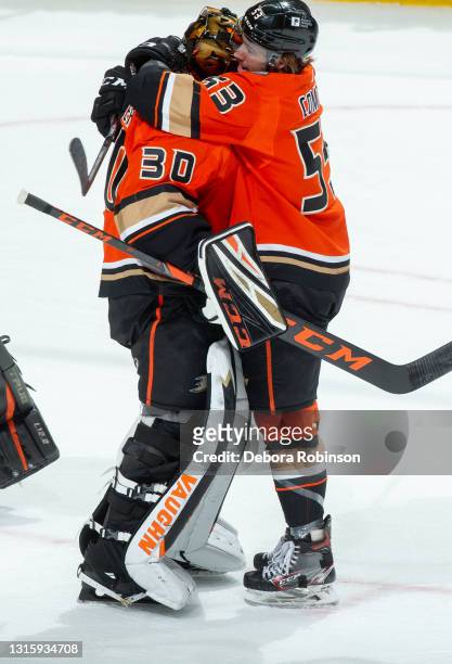 Goaltender Ryan Miller of the Anaheim Ducks is congratulated by Max Comtois of the Anaheim Ducks after his final career home game, a 6-2 win over the...