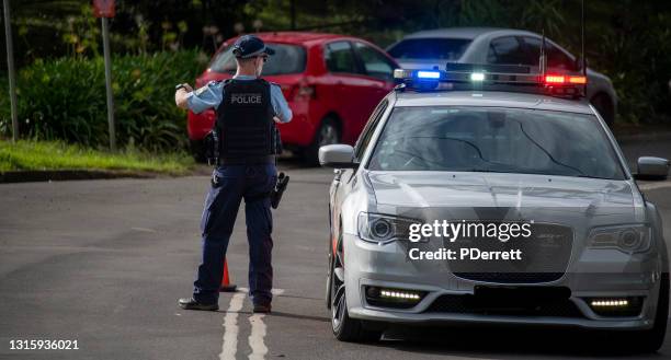 policeman on duty at the nimbin mardi grass street parade. - emergency services australia stock pictures, royalty-free photos & images