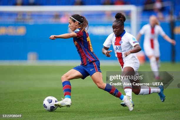 Aitana Bonmati of FC Barcelona breaks away from Sandy Baltimore of Paris Saint-Germain during the UEFA Women's Champions League Semi Final match...