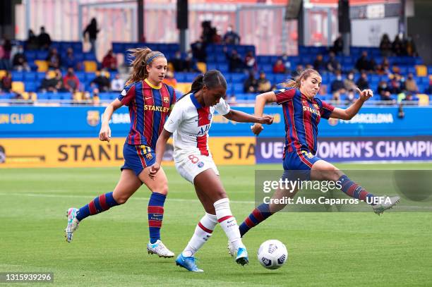 Grace Geyoro of Paris Saint-Germain plays the ball past Alexia Putellas and Patri Guijarro of FC Barcelona during the UEFA Women's Champions League...