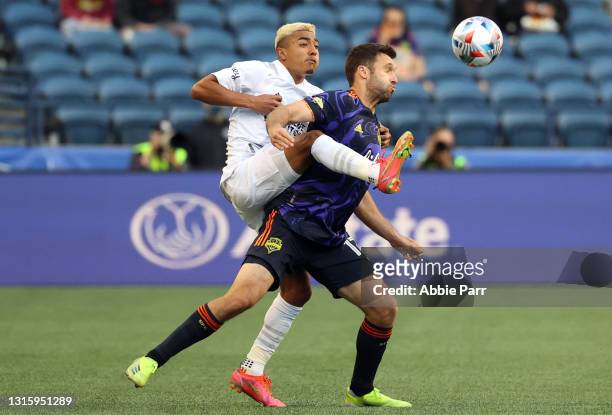 Julian Araujo of Los Angeles Galaxy and Will Bruin of Seattle Sounders battle for possession in the second half at Lumen Field on May 02, 2021 in...