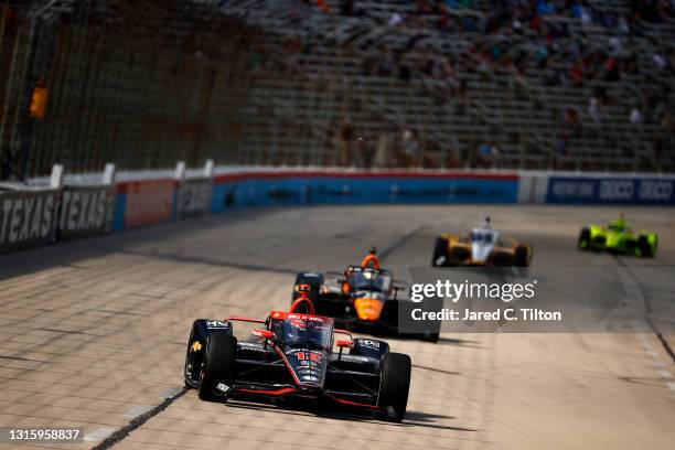 Will Power of Australia, driver of the Verizon 5G Team Penske Chevrolet, leads a pack of cars during the NTT IndyCar Series XPEL 375 at Texas Motor...