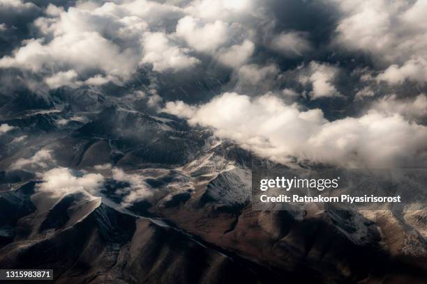 beautiful sandstone himalayan mountains with snow. view from the airplane of leh - ladakh, northern india. - aerial view of clouds and earth landscape stock pictures, royalty-free photos & images