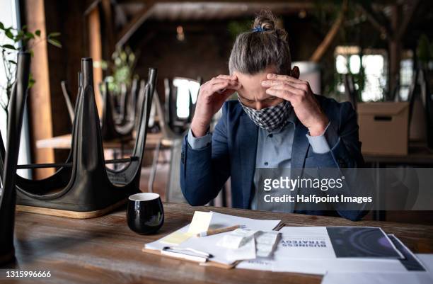 frustrated manager of restaurant working at table, coronavirus and end of business concept. - business plan covid stock pictures, royalty-free photos & images