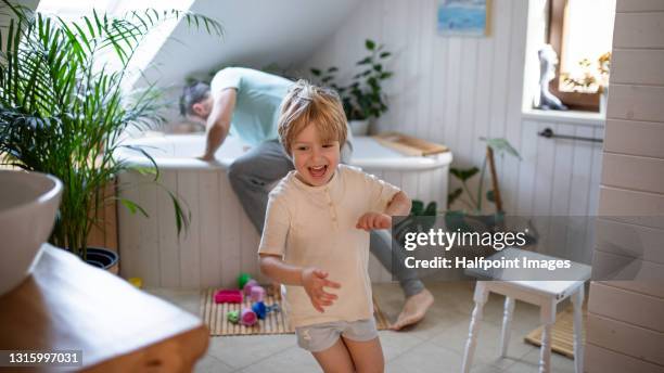 father with small son in bathroom at home, preparing for a bath. - brothers bathroom bildbanksfoton och bilder