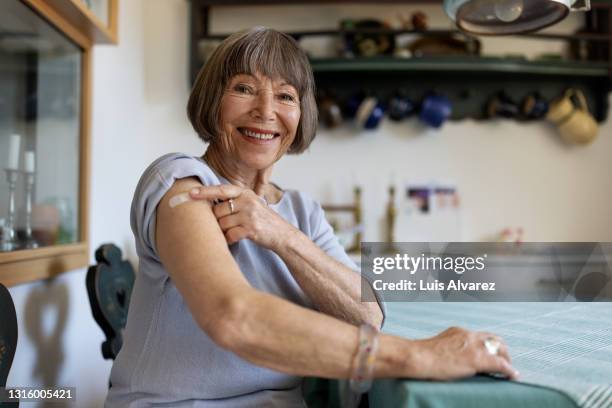 senior woman feeling proud after getting covid-19 vaccine - vaccine confidence stock pictures, royalty-free photos & images