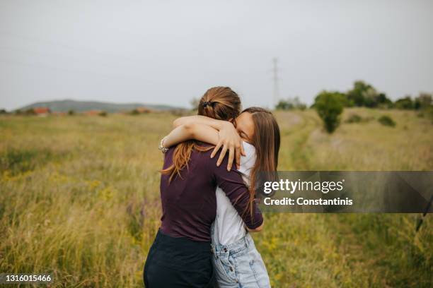 true friendship hug - girls hugging stock pictures, royalty-free photos & images