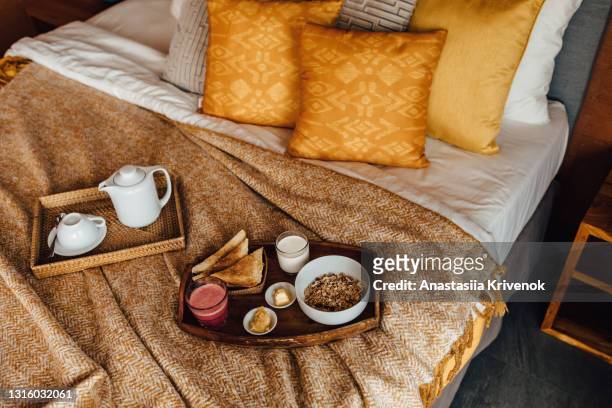 healthy breakfast on the bed in cozy bedroom. - weekend activities stock pictures, royalty-free photos & images