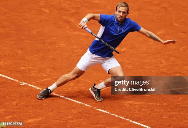 Dan Evans of Great Britain hits a backhand during his match against Jeremy Chardy of France at La Caja Magica on May 03, 2021 in Madrid, Spain.