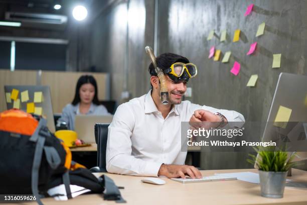 businessman working on line or searching travel destinations with goggles needing vacations at office - time off work stock pictures, royalty-free photos & images