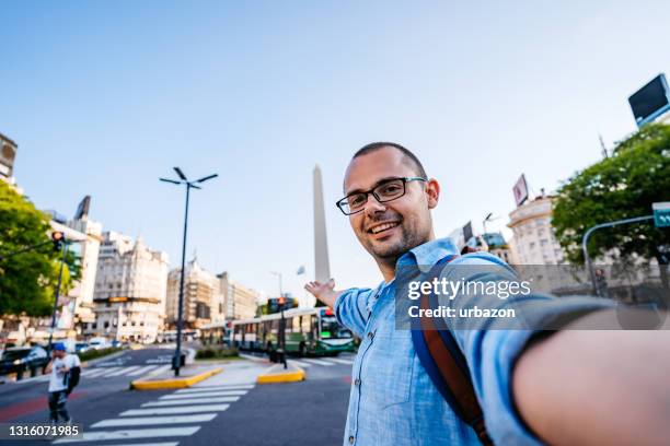 man making selfie with obelisk from buenos aires - obelisco stock pictures, royalty-free photos & images