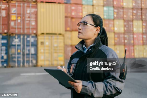 asian female worker working at container terminal - safe harbor stock pictures, royalty-free photos & images