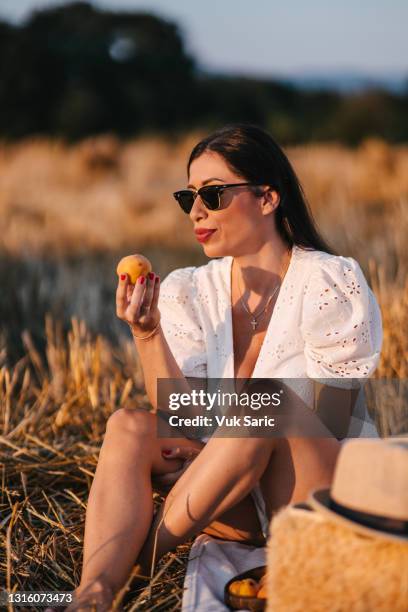 woman preparing to eat peach - peach tranquility stock pictures, royalty-free photos & images