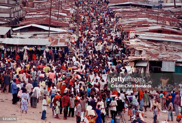 Thousands of people crowd the main market in thetown of Port Harcourt in March 2001 in the Nigerian delta.