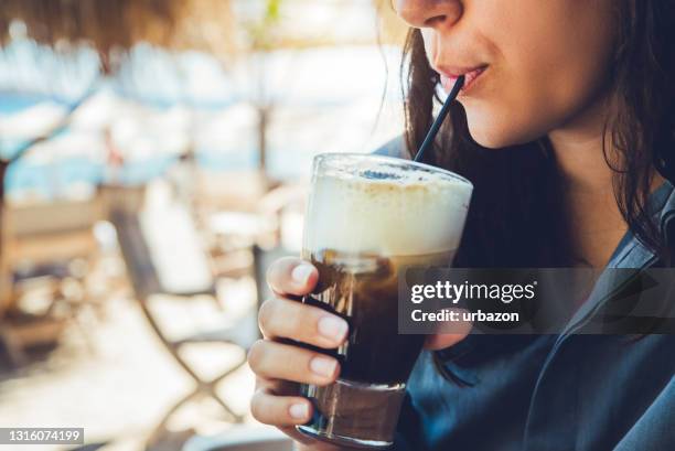 woman drinking iced coffee - ice coffee stock pictures, royalty-free photos & images