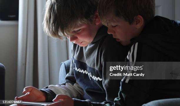 Nine and ten-year-old boy use a iPad to play video games on May 2 in Bath, England. Research has shown that children in the UK aged between 5‐16...