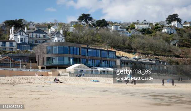 People enjoy a day on the beach in front of The Carbis Bay Hotel and Estate at Carbis Bay, which is set to be the main venue for the upcoming G7...