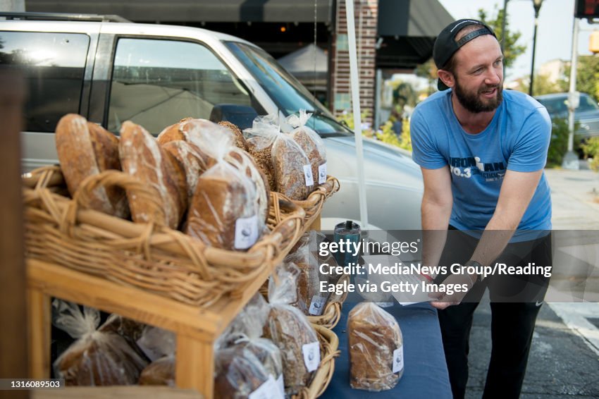 West Reading Farmer's Market Daniel Price of the Daily Loaf helps a customer pick out bread. Special to the Reading Eagle: Susan L. Angstadt 9/23/2019