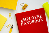 Employee handbook guide on the office desk.