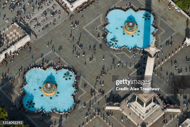 an aerial view of trafalgar square in london busy with crowds of people - trafalgar square stock pictures, royalty-free photos & images