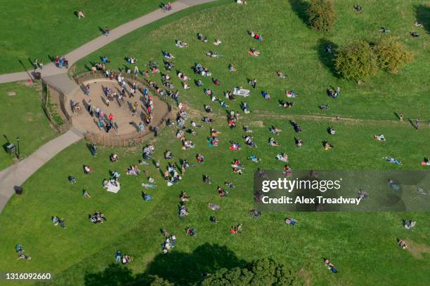 an aerial view of primrose hill next to regents park in north london with crowds of people - regents park stock pictures, royalty-free photos & images