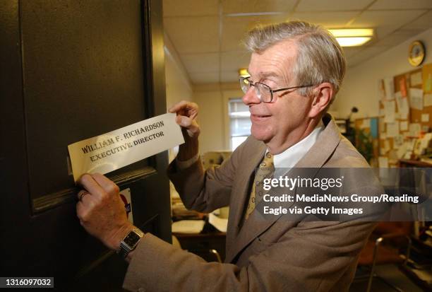 Photo by Tim Leedy 12/13/05William F. Richardson executive director of Berks Community Action Program, removes the nameplate from his office door as...