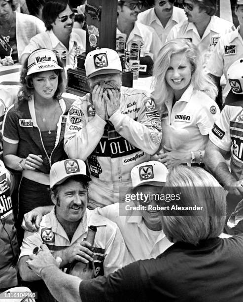 Driver Cale Yarborough wipes his face in Victory Lane after winning the 1981 Firecracker 400 stock car race at Daytona International Speedway in...