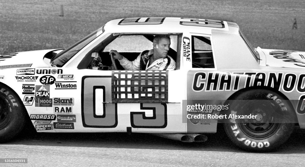 NASCAR driver David Parson sits in his racecar prior to the start of ...