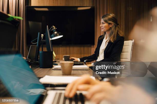 female lawyer working on computer in board room at office - lawyer computer stock pictures, royalty-free photos & images