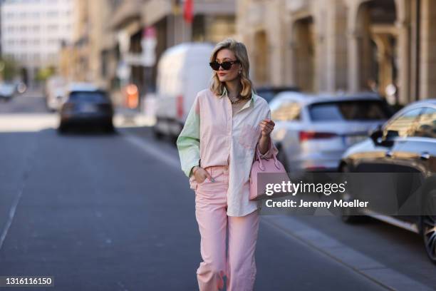 Mandy Bork wearing pink Zara jeans, pink Bonaventura leather bag, Storets flanell and Bottega Veneta shades on April 27, 2021 in Berlin, Germany.