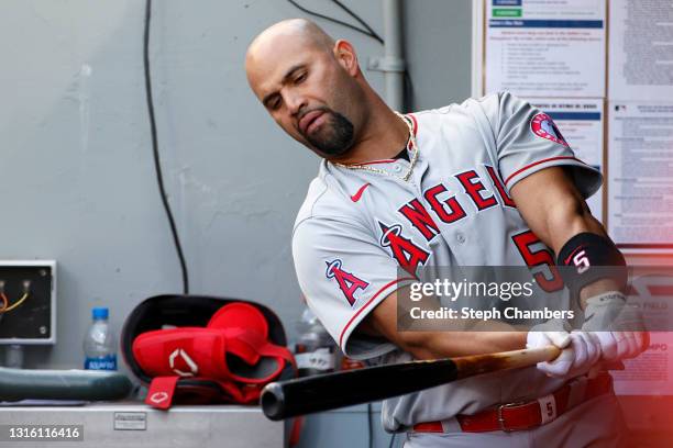 Albert Pujols of the Los Angeles Angels swings his bat in the dugout during the game against the Seattle Mariners at T-Mobile Park on May 02, 2021 in...