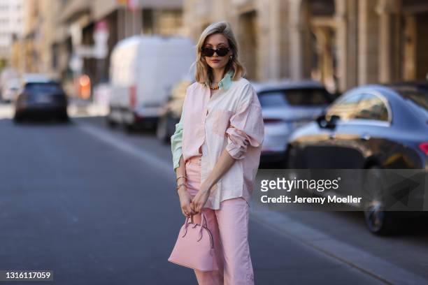 Mandy Bork wearing pink Zara jeans, pink Bonaventura leather bag, Storets flanell and Bottega Veneta shades on April 27, 2021 in Berlin, Germany.