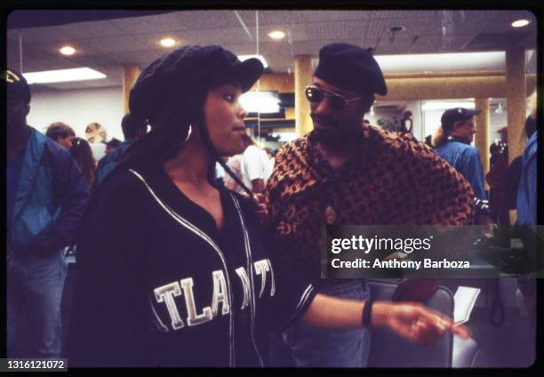 View of American singer and actress Janet Jackson as she talks with film director John Singleton during the making of their film 'Poetic Justice,'...
