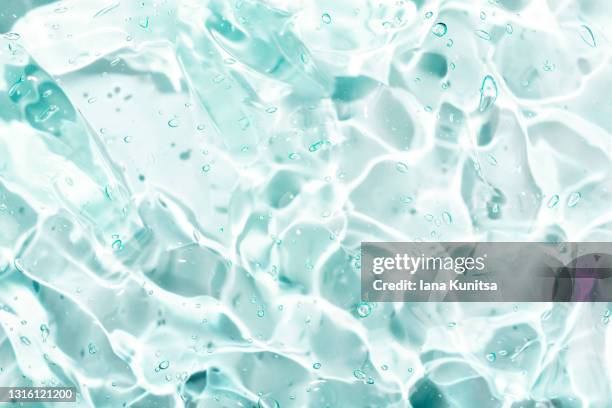 transparent blue smudged of liquid moisture serum for face. hydrating hyaluronic acid. antibacterial gel with bubbles. cosmetic products for makeup and skin care. cosmetology. - jelly stock pictures, royalty-free photos & images