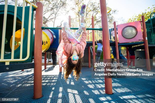 Robin Heilweil swings around with her kindergarten class at Kenter Canyon School in Brentwood during the reopening of playgrounds at early education...